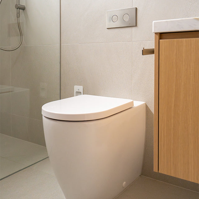 Caroma Liano brushed nickel taps, accessories and Urbane II Cleanflush toilet suite | Timberline shaving cabinet | Modern Bathroom Renovation | The Blue Space