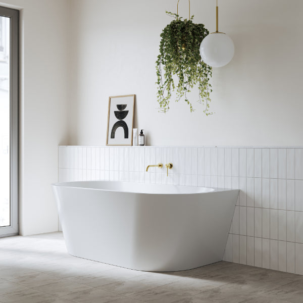Bao Bon Back to Wall Bath in stylish white minimal bathroom with gold accents. Side view - The Blue Space