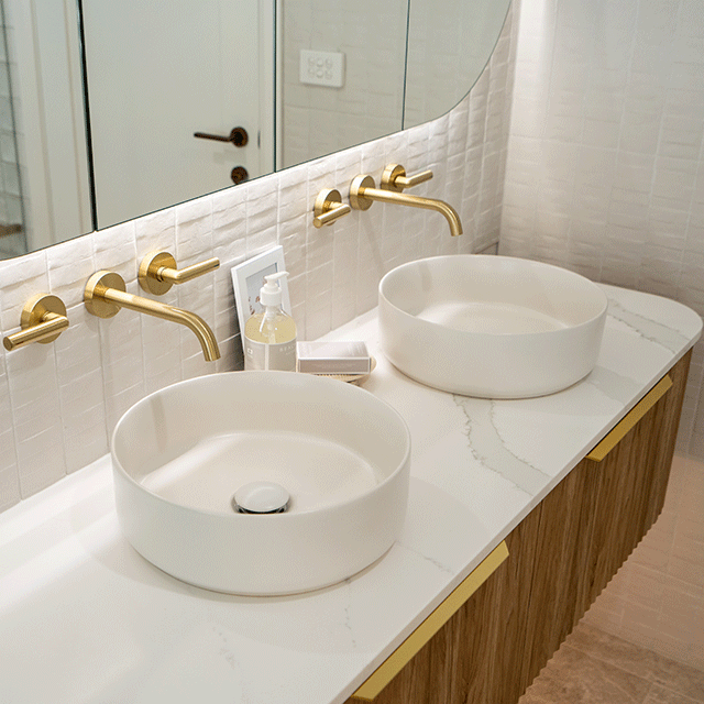 Timberline Santos Apollo Fluted Wall Hung Vanity with SilkSurface Top and Above Counter Basin paired with Phoenix Vivid Slimline Plus Lever Wall Top Assemblies Brushed Gold